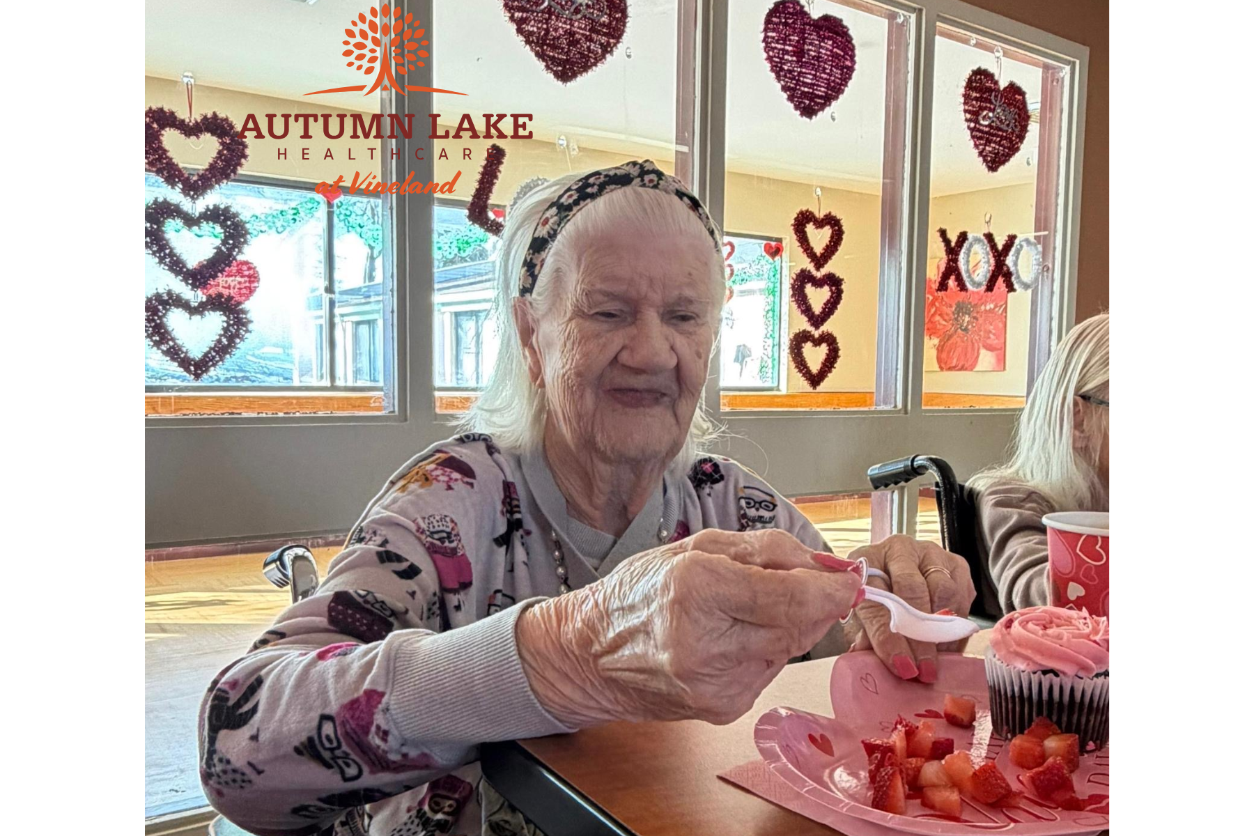 An elderly resident in a senior living community enjoys a Valentine's Day treat